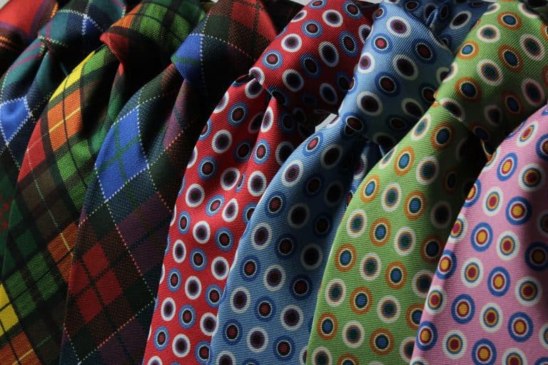 A vibrant assortment of patterned neckties displayed together. Ideal for fashion themes.